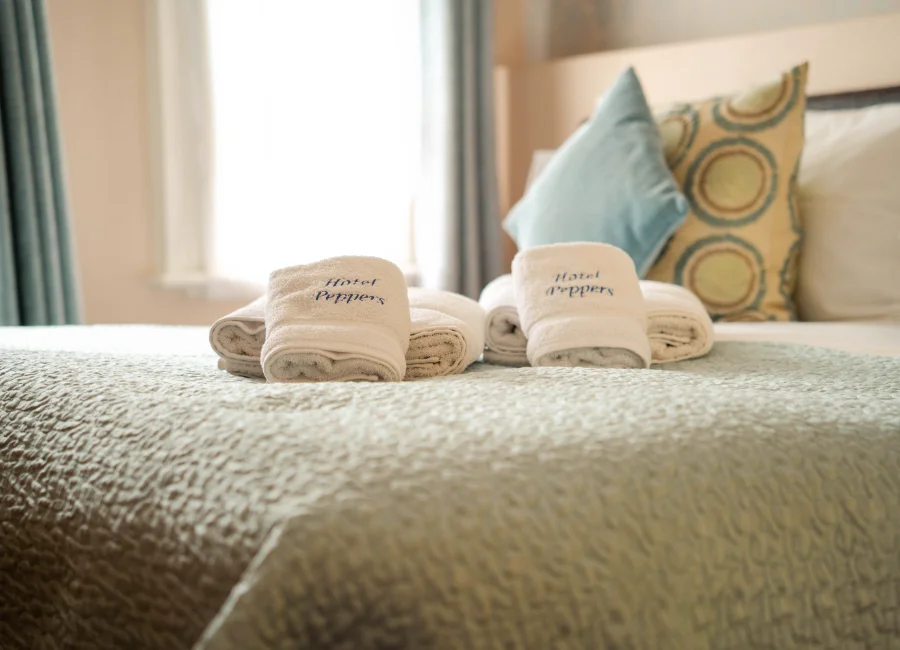Bed with patterned cushions and neutral throw